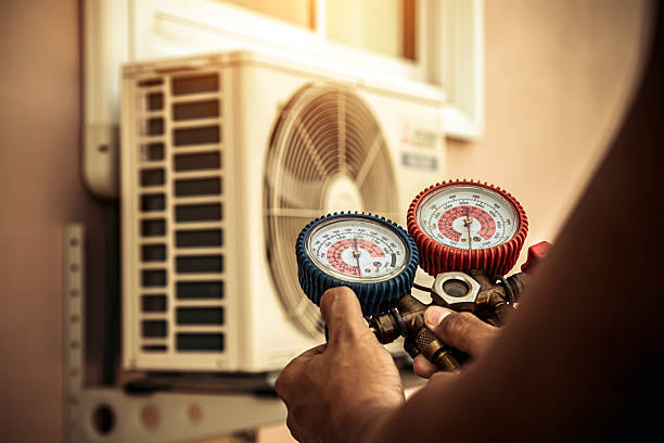 Professional Air Conditioning Service technician working in Huntsville, TN